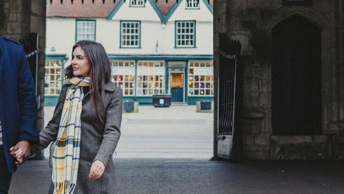Couple walking through Abbey Gate 1500x390