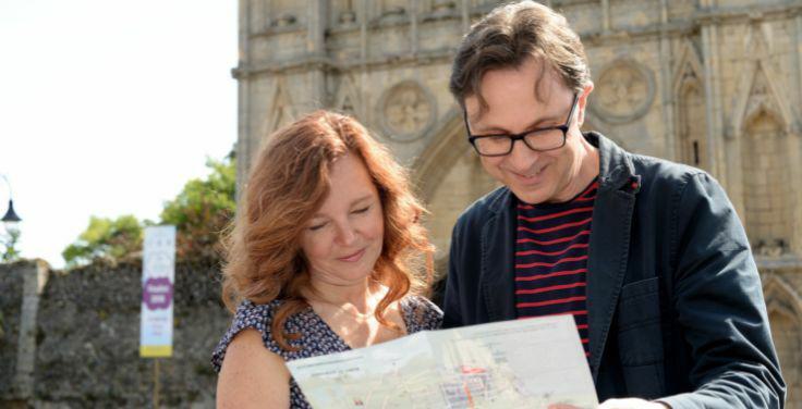 Couple reading visitor guide 736x376